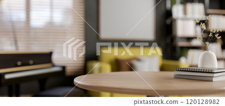 A wooden round table with a blurred background of a modern mid-century living room. 120128982