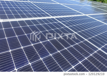 Solar panels lined up under a clear blue sky at a solar power plant Solar panels lined up under a clear blue sky at a solar power plant 120129210