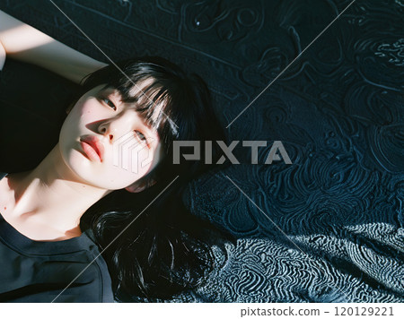 Asian woman in a relaxed mood with a languid look 120129221