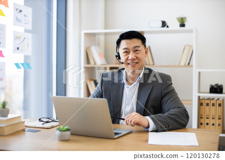 Asian businessman having an online video call in modern office 120130278