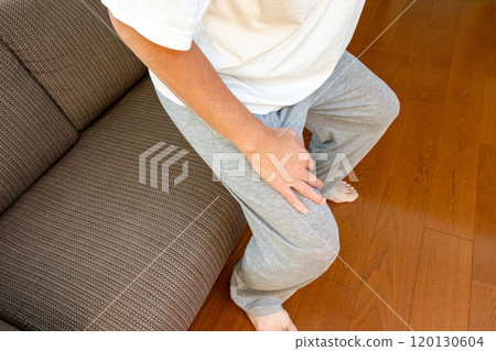 Man getting up from sofa 120130604
