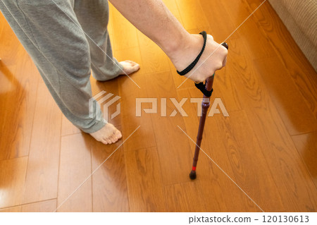 A person standing with a cane in a room A person standing with a cane in a room 120130613
