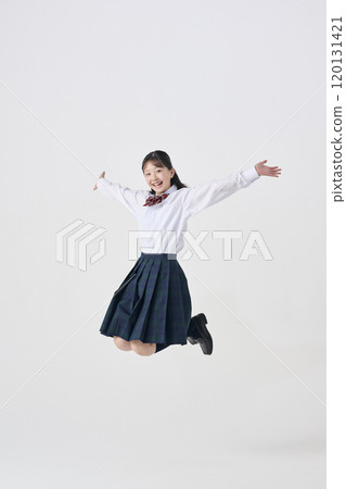 White background, Japanese female junior high school student jumping with a smile 120131421