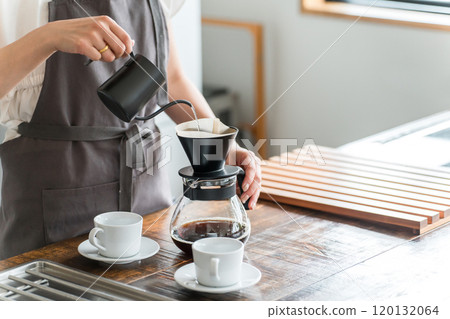 Woman making coffee in kitchen cafe 120132064