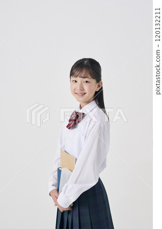 White background, Japanese female junior high school student holding study materials 120132211