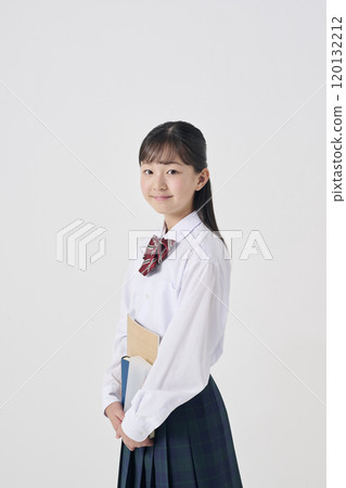White background, Japanese female junior high school student holding study materials 120132212
