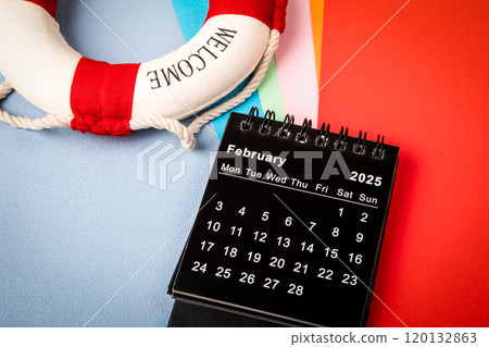 February 2025. Monthly desk calendar for 2025 year. Colorful sheets of paper on the office table 120132863