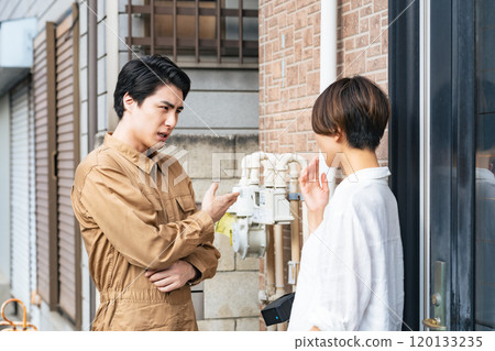 Residents and workers talking in front of a house Residents and workers talking in front of a house 120133235