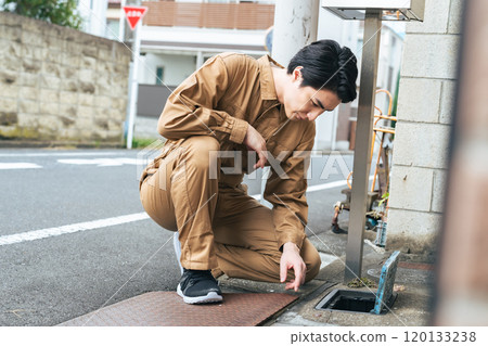 Worker checking the water meter 120133238