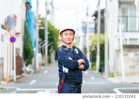 Senior worker standing in a residential area 120133243