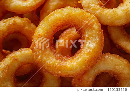 Photography of crispy fried onion rings, close-up top view 120133536