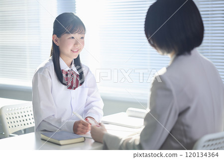 Female junior high school student being taught by a cram school teacher Female junior high school student being taught by a cram school teacher 120134364