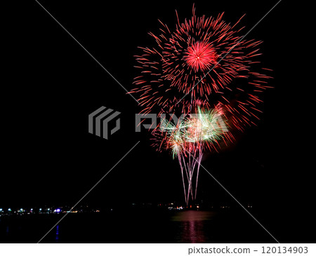 A large and bright fireworks display filling the night sky with glitter and sparks. Celebration background.   A large and bright fireworks display filling the night sky with glitter and sparks. Celebration background.   120134903