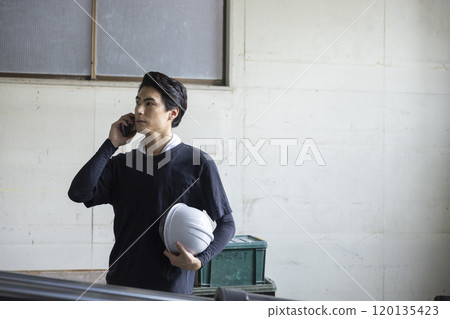 Male worker making a phone call 120135423