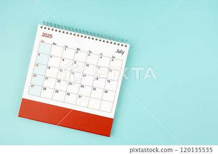 July 2025 desk calendar on blue background for your appointment. 120135535