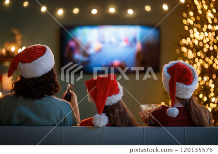 family watching holiday movies at home family watching holiday movies at home 120135576