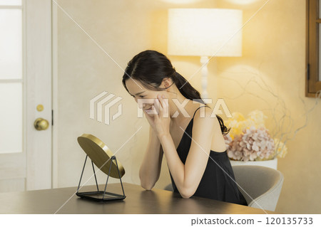 Skin care for a young woman in the living room at night 120135733
