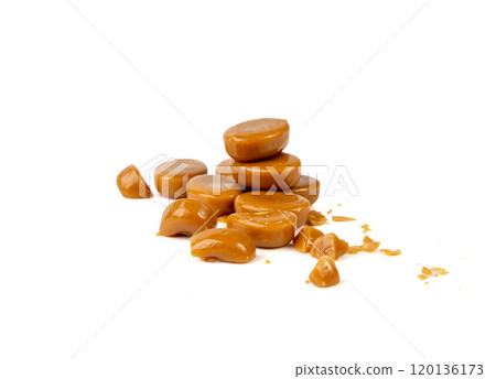 Broken caramel candies isolated, toffee caramel crumbs, round hard milk confectionery pieces 120136173