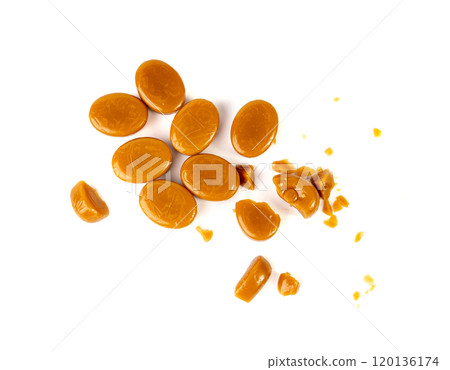Broken caramel candies isolated, toffee caramel crumbs, round hard milk confectionery pieces Broken caramel candies isolated, toffee caramel crumbs, round hard milk confectionery pieces 120136174