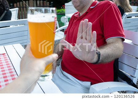 Reject a glass of beer, woman refusing alcohol, stop drinking, sobriety concept, saying no to beer glass Reject a glass of beer, woman refusing alcohol, stop drinking, sobriety concept, saying no to beer glass 120136526