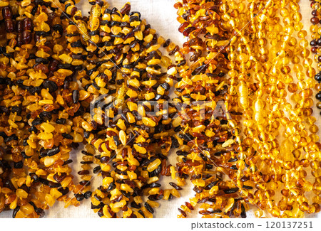 Amber stones market, polished orange gemstones closeup, natural Baltic amber gems jewelry store Amber stones market, polished orange gemstones closeup, natural Baltic amber gems jewelry store 120137251