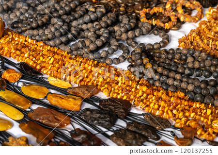 Amber stones market, polished orange gemstones closeup, natural Baltic amber gems jewelry store Amber stones market, polished orange gemstones closeup, natural Baltic amber gems jewelry store 120137255