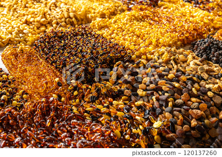 Amber stones market, polished orange gemstones closeup, natural Baltic amber gems jewelry store 120137260