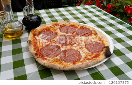 Pepperoni Pizza on Restaurant Plate, Salami Pizza with Olives, Tomatoes and Mozzarella Cheese 120137275