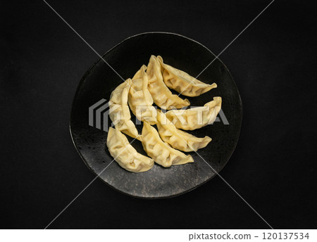 Gyoza Chinese Dumplings Top View, Vegetable Jiaozi, Chicken Momo Pile, Asian Gyoza Portion on Black 120137534