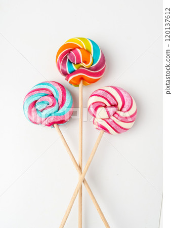 Color lollipop, spiral candy on stick, colorful striped lollypop, round fruit caramel, circle lollipop 120137612