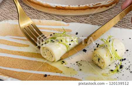 Rolls filled with cream cheese, cold appetizer, Georgian cuisine. White small cheese rolls 120139512