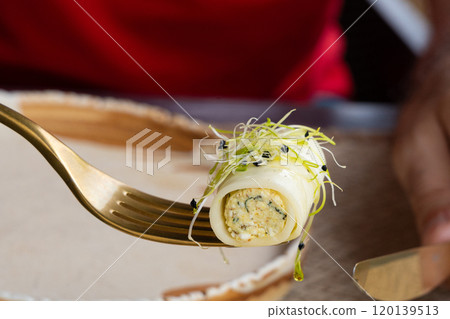 Rolls filled with cream cheese, cold appetizer, Georgian cuisine. White small cheese rolls 120139513