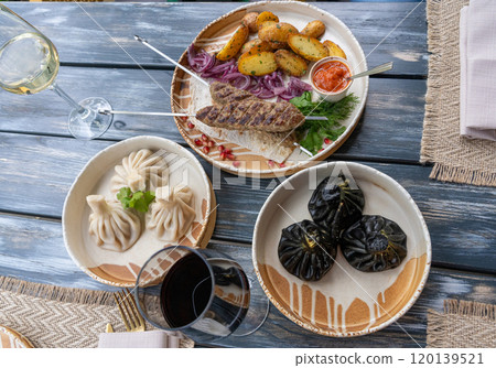 Black khinkali, Georgian seafood chinkali, spicy dumplings with minced meat also called dimsum 120139521