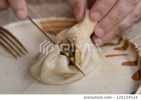 Georgian khinkali, minced meat chinkali, spicy dumplings also called dimsum, momo, jiaozi, manti Georgian khinkali, minced meat chinkali, spicy dumplings also called dimsum, momo, jiaozi, manti 120139524