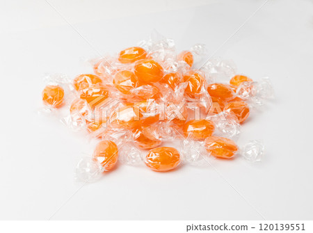 Orange hard candies isolated. Scattered lollipop pile, wrappers fruit confectionery group, round sweets Orange hard candies isolated. Scattered lollipop pile, wrappers fruit confectionery group, round sweets 120139551