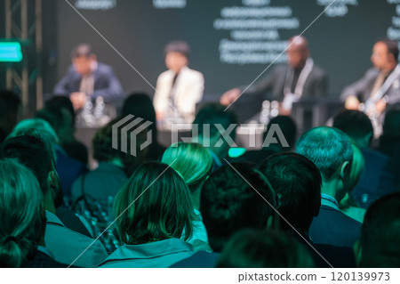 Audience attending a business conference with panel discussion Audience attending a business conference with panel discussion 120139973