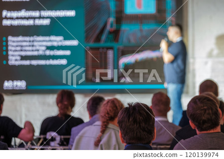 Business professional delivering a presentation at a technology conference Business professional delivering a presentation at a technology conference 120139974