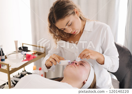 Professional female cosmetologist doing procedure in Cosmetology clinic. Rejuvenation and Hydratation. Professional female cosmetologist doing procedure in Cosmetology clinic. Rejuvenation and Hydratation. 120140220