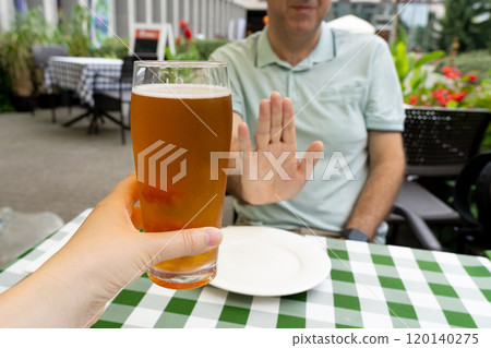 Reject a glass of beer, man refusing alcohol, stop drinking, sobriety concept, saying no to beer glass Reject a glass of beer, man refusing alcohol, stop drinking, sobriety concept, saying no to beer glass 120140275