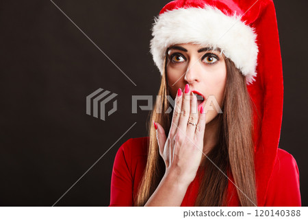Surprised woman wearing santa claus hat Surprised woman wearing santa claus hat 120140388