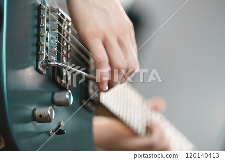 Close up of man playing on electric guitar 120140413