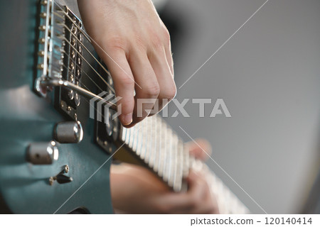 Close up of man playing on electric guitar 120140414