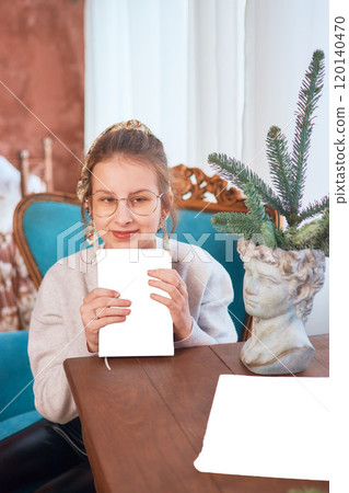 teenage girl reading a book sitting in an armchair, mockup 120140470