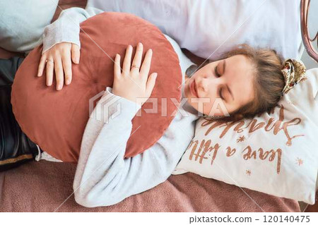 fragile teenage girl in bed hugging pillows fragile teenage girl in bed hugging pillows 120140475