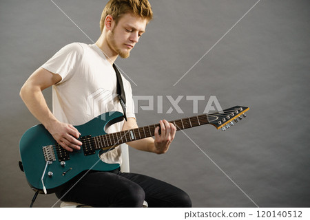 Man playing on electric guitar Man playing on electric guitar 120140512