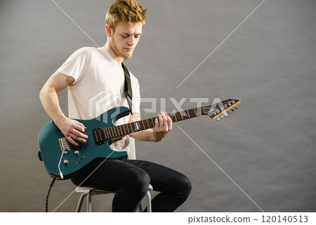 Man playing on electric guitar Man playing on electric guitar 120140513