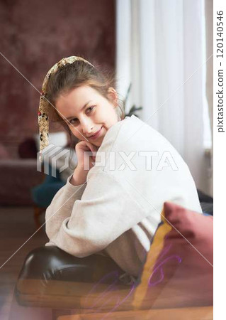 portrait of a teenage girl sitting in a comfortable chair at home, studio photo session portrait of a teenage girl sitting in a comfortable chair at home, studio photo session 120140546