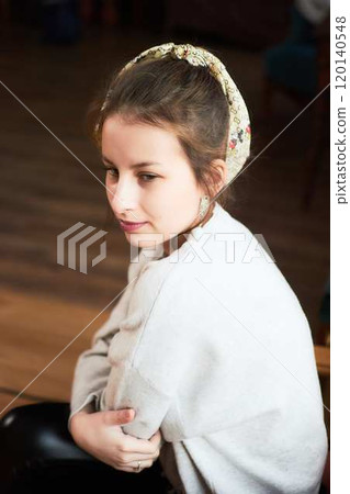 portrait of a teenage girl sitting in a comfortable chair at home, studio photo session 120140548