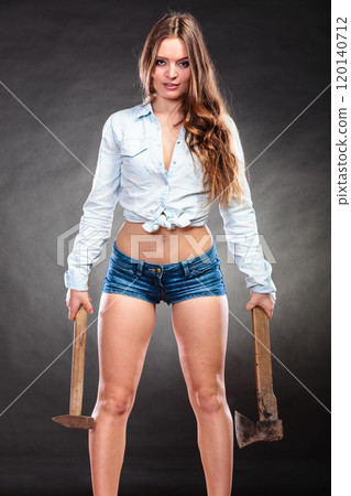 Sexy alluring woman holding hammer and axe. 120140712
