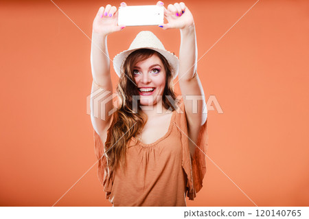 Woman taking self picture with smartphone camera Woman taking self picture with smartphone camera 120140765
